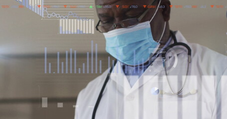 Senior Black male doctor analyzing digital patient data in clinical hallway, with stethoscope mask