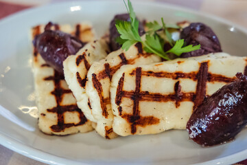 Grilled Halloumi - traditional Cypriot cheese and sausages on a plate in Cyprus island country