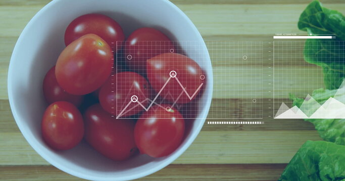 Displaying bowl of cherry tomatoes and lettuce on board in kitchen, graph overlay, copy space