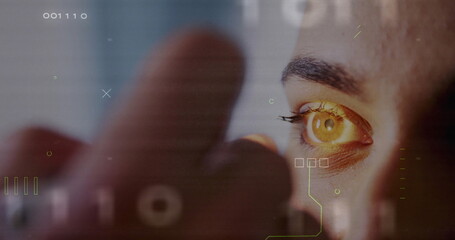 Scanning human eye and index fingertip projecting HUD graphics in tech station, with numeric codes