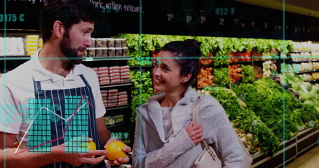 Talking employee wearing striped apron and shopper selecting orange in produce area with signage
