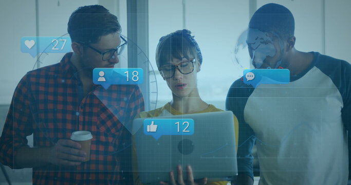 Collaborating colleagues leaning around laptop at office, with floating social media metrics