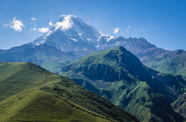 Fototapeta premium Aerial view in Greater Caucasus Mountains with Mount Kazbek near Gergeti village and Stepantsminda town, Georgia