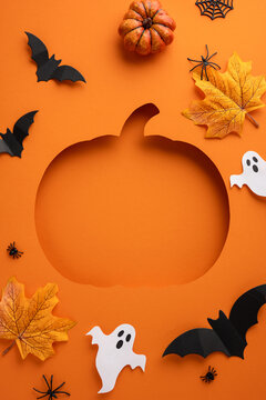 Festive vertical Halloween-themed orange background featuring a pumpkin cutout, bats, ghosts, leaves, and spiders