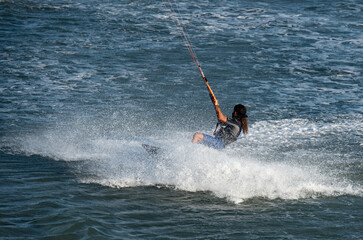 Kitesurfer enjoying the waves on a sunny day