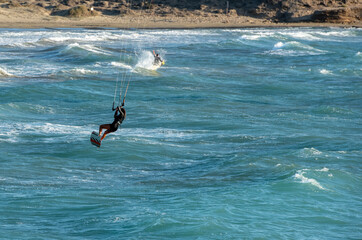 Kitesurfer enjoying the waves on a sunny day