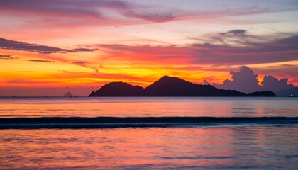 Vibrant sunset painting the serene ocean and distant islands