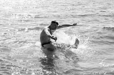 Portrait of a happy guy swimming in the sea