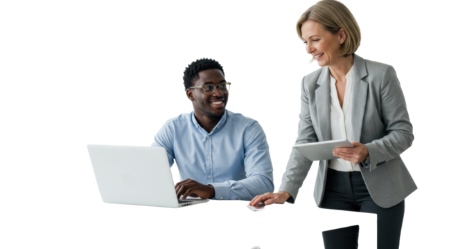 Young black man, early 30s, glasses, and a caucasian woman, late 40s, blazer, smiling, discussing ideas with tech on a white table, white studio background. Concept of inclusive collaboration