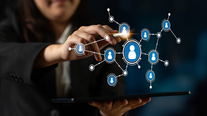 A business professional interacts with digital networking icons on a tablet, showcasing modern communication and technology role in professional environments. Tessel