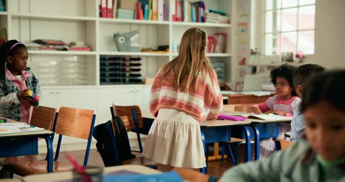 Kids, organize desk and start class for learning, education and academic development in elementary. Girl, school and children prepare for lesson with stationery, classmates and students in classroom