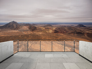 Panoramic desert mountain landscape with dramatic cloudy sky, rocky hills, dry valley, and scenic...