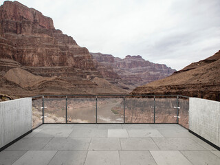 Panoramic desert mountain landscape with dramatic cloudy sky, rocky hills, dry valley, and scenic...