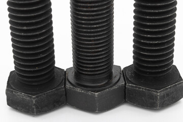 High strength black screw, hex head on a white backgroundHigh strength black screw, hex head on a...