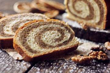 Walnut roll on a wooden background. Croatian orehnjaca