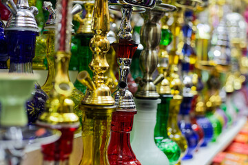 Display of Ornate Hookah Pipes in Market Setting Showcasing Traditional Artisan Craftsmanship