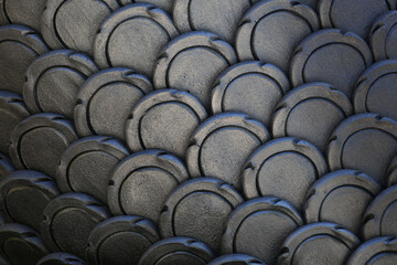 Obraz premium Gray patterns of stucco shaped like fish scales.