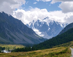 Naklejka premium Majestic snow-capped mountains rise above a valley carpeted in green forests and grasslands, showcasing a breathtaking landscape.