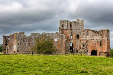 Stone walls of historic 13th century Brougham Castle in the English countryside