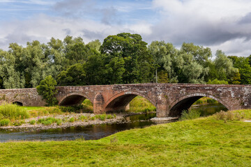 Old stone arched bridge crossing the River Eamont near Penrith in Cumbria, England