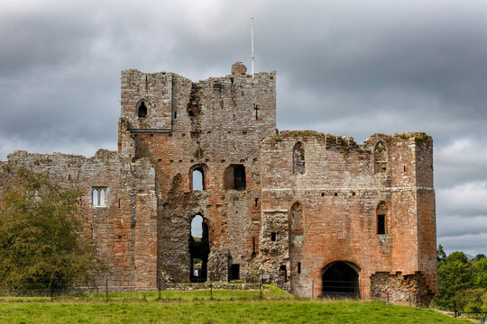 Crumbling walls and gatehouse of a 13th-century English castle ruin near Penrith.