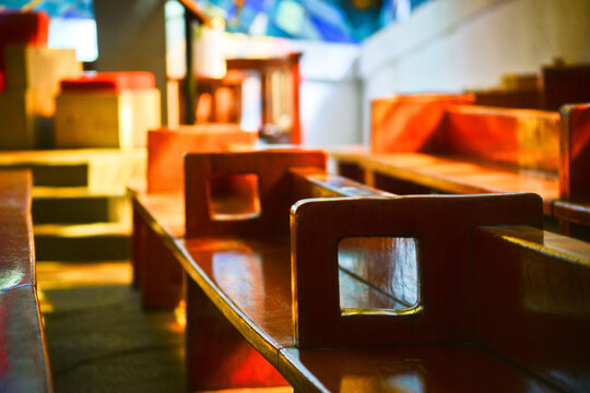 Wooden bench from a Curch under yellow light 