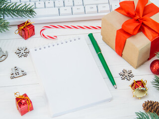 The desk in the office, decorated with pine branches and Christmas toys, created a sense of...