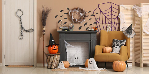 Interior of living room with fireplace, armchair, pumpkins and Halloween decorations