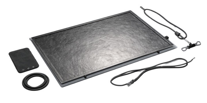 Flat rectangular display with accessories.  Grey textured screen, several cables, and a small box.  Surrounding components suggest a portable, self-contained device