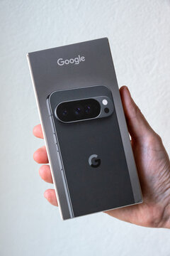 Google Pixel 10 Pro XL box being held in a male hand