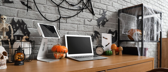 Interior of office decorated for Halloween with workplace and shelf unit