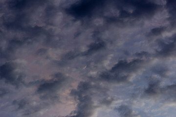 Stormy sky with thunderclouds and moon in the evening.