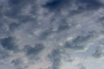 Stormy sky with thunderclouds and moon in the evening.