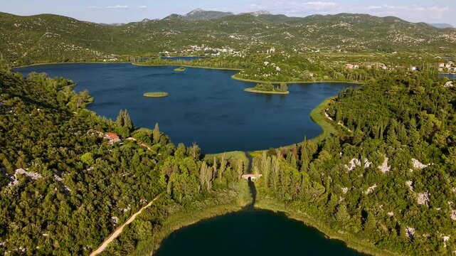 Bacina Lakes Ploce Croatia aerial panorama of emerald lakes tiny islets cypress rows and surrounding karst mountains