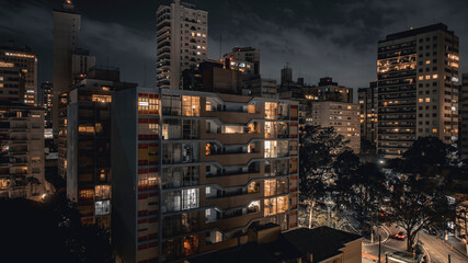 Night view of residential buildings in Higienopolis São Paulo with cinematic bleach bypass style...