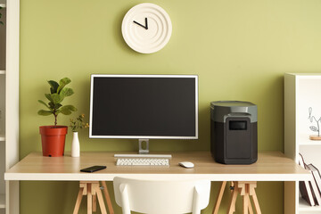 Workplace with computer and portable power station in office