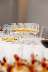 Elegant wine glasses and appetizers on a catering table for a luxury event