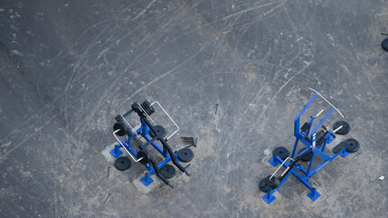 Outdoor gym equipment with weights installed on asphalt ground viewed from above  

