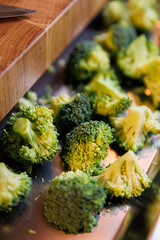 Close-up of fresh broccoli florets on a metal tray, ready for cooking or healthy meal prep