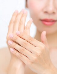 Fototapeta premium Close-up of woman's hands applying lotion