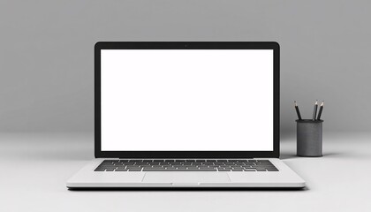 A silver laptop with a blank white screen sits on a white surface next to a gray pencil holder containing several black pencils, all against a gray background.