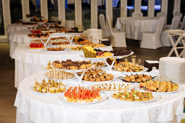 Luxurious banquet table with assorted finger foods and snacks at a formal event