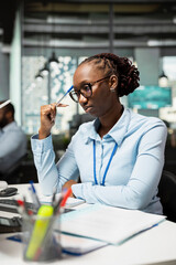 Equity analyst examining company earnings reports to forecast stock shares valuation. Woman working...