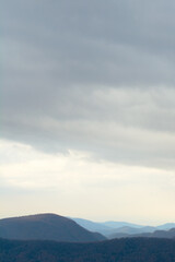 A breathtaking autumn sunrise where golden mountain slopes blaze with fall colors against the deep blue dawn sky.