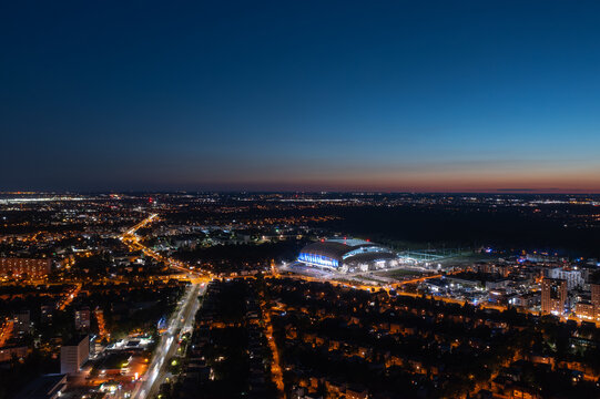 Poznań, Poland - August 2025: Aerial panoramic night view of illuminated city stadium (Stadion Miejski, ENEA Stadion), home for football club Lech Poznan KKS