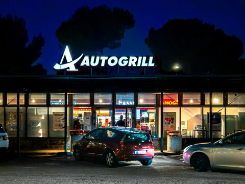 Bordighera, Italy - August 30, 2025: Night view of the Autogrill Bordighera Sud service area with illuminated sign on the A10 Autostrada dei Fiori motorway.