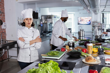 Female culinary artist preparing fine dining meals with fresh produce, doing food prep and cooking with stainless steel tools or utensils. Professionalism and attention to detail.