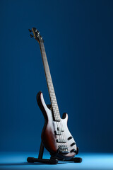 Modern electric guitar on dark blue background