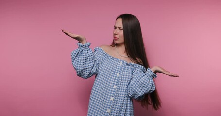 Young woman expressing confusion in casual outfit against a pink background - Powered by Adobe
