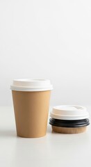 Two disposable coffee cups on a plain white background ready for beverages to be served to customers